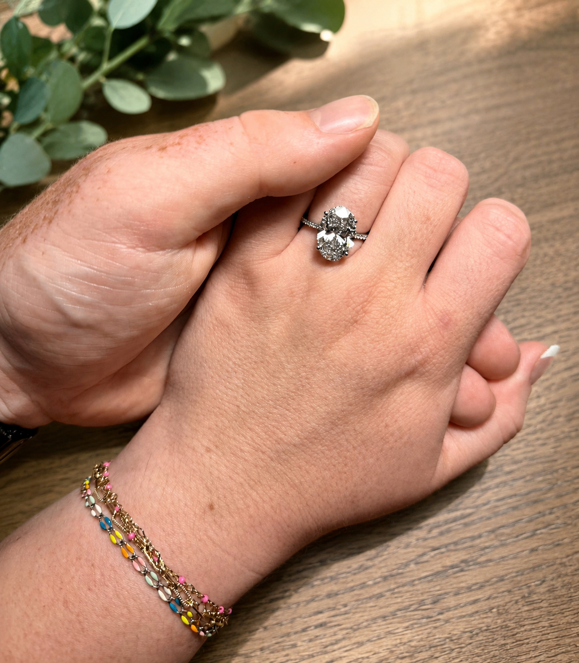 Luke and Lydia's hands, showing the engagement ring